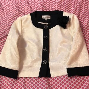 A white/cream colored jacket/shall.
